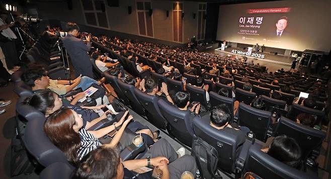정부 청사진에 쏠린 눈 파이낸셜뉴스와 과학기술정보통신부가 공동주최한 'AI 월드 2025'가 25일 서울 송파구 롯데월드타워 롯데시네마에서 열린 가운데 이민주 대통령실 국정홍보비서관이 이재명 대통령의 축사를 대독하고 있다. 제리 카플란 스탠퍼드대 교수와 임문영 국가인공지능전략위원회 상근부위원장의 기조연설로 시작된 이날 행사에는 1300명이 넘는 인파가 몰렸다. 사진=박범준 기자