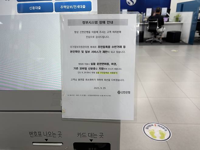 29일 여의도에 위치한 한 신한은행 영업점에 국정자원 화재로 본인 인증시 실물 운전면허증 등이 필요하다는 이용 안내가 붙어있다./사진=김정후 기자 kjh2715c@