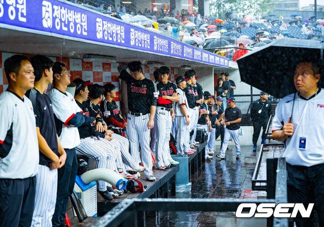 [OSEN=대전, 민경훈 기자] 28일 오후 대전 한화생명볼파크에서 2025 신한 SOL Bank KBO리그 한화 이글스와 LG 트윈스의 경기가 열릴 예정이지만 그라운드에 비가 내리고 있다.프로야구 LG 트윈스의 정규리그 우승 확정이 걸린 대전 경기가 폭우 속에서도 개최 준비를 한다. 경기 개시 시간을 1시간 늦춰 들어갈 예정이다. 빗줄기가 다시 굵어지자 LG 선수들이 덕아웃 안으로 비를 피하고 있다. 2025.09.28 / rumi@osen.co.kr