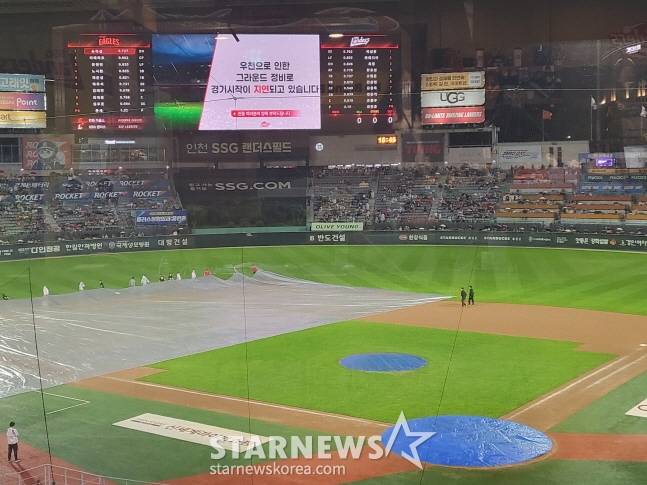 스태프들이 방수포를 걷고 있다. /사진=안호근 기자
