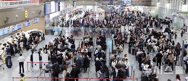 [부산=뉴시스] 하경민 기자 = 추석 연휴를 앞둔 2일 부산 강서구 김해국제공항 국제선 청사에서 해외여행을 떠나는 시민들이 출국 수속을 하고 있다.    이번 추석 연휴 기간(2~12일) 전국 15개 공항 이용객은 역대 명절 연휴 최대인 약 526만명에 달할 것으로 전망됐다. 인천공항이 245만명, 김포·김해·제주 등 14개 공항이 281만명(국내선 206만명, 국제선 75만명)으로 예상됐다. 한국공항공사는 국제선 출발 2시간 전까지 공항 도착을 권고했다. 2025.10.02. yulnetphoto@newsis.com