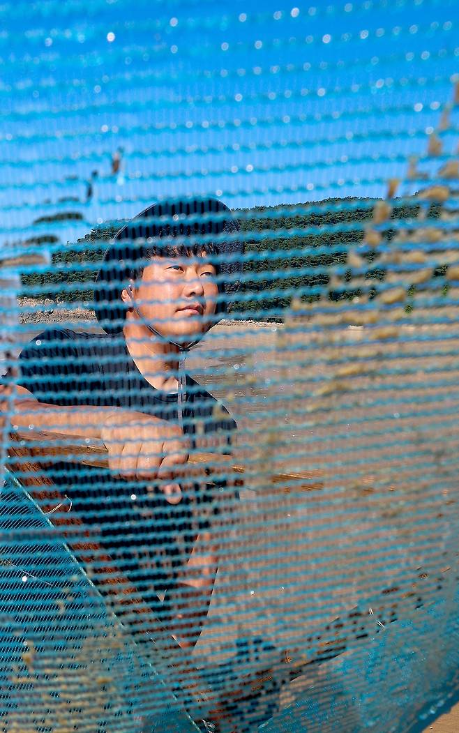 ▲ 지난 10일 인천 옹진군 대이작도에서 김민욱(32) 청년회장이 곤쟁이 잡이용 그물을 살펴보고 있다. /인천일보