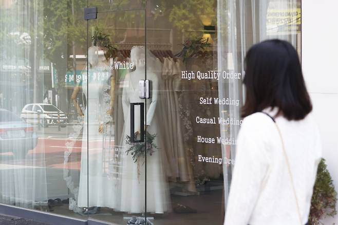 Wedding dresses on display at a bridal shop on Wedding Street in Ahyeon-dong, Mapo District, Seoul. [YONHAP]