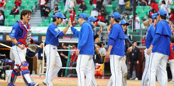 The Samsung Lions celebrate winning Game 1 of the first round of KBO playoffs against the SSG Landers at Incheon SSG Landers Field in Incheon on Oct. 9. [YONHAP]