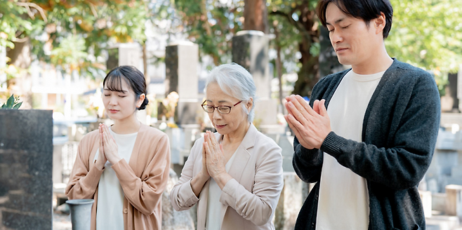 오히간을 맞아 성묘하는 사람들. 닛폰코도.