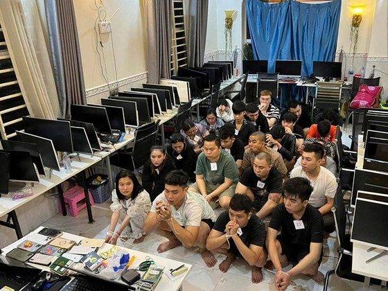 지난 7월 캄보디아 시아누크빌의 한 빌딩에서 수사 당국에 검거된 온라인 사기조직 용의자들이 포승줄에 묶여 범행 현장에 앉아 있다.연합뉴스