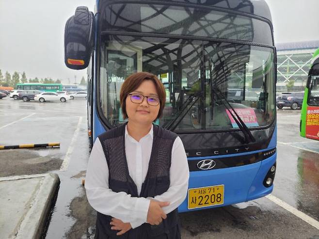 Yoon Soo-jung, who has been working as a city bus driver for two years and seven months, poses in front of the Gonghang Bus depot in Gaehwa-dong, Seoul, on October 14. / Courtesy of Seoul Bus Transport Business Association