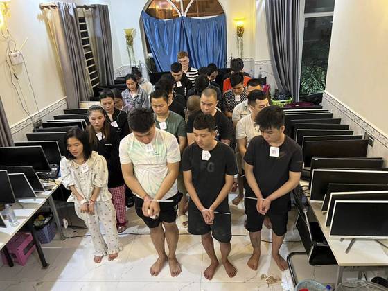 In this photo released by Agence Kampuchea Press, online scammers arrested by authorities stand in a building in Sihanoukville province, southwest of Phnom Penh, Cambodia, on July 15. [AP/YONHAP]