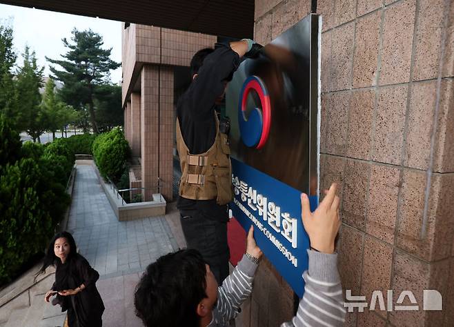 [과천=뉴시스] 조성우 기자 = 지난 1일 오전 경기도 과천시 정부과천청사에서 관계자가 방송통신위원회 현판 철거 작업을 하고 있다. 2025.10.01. xconfind@newsis.com