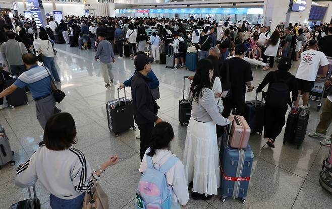 추석 연휴 첫날인 지난 3일 인천국제공항 제1여객터미널에서 여행객들이 탑승 수속을 위해 줄을 서고 있다. 연합뉴스