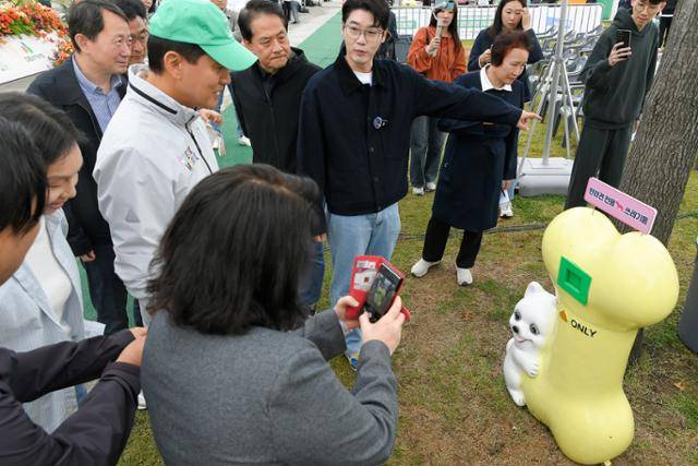 오세훈(왼쪽 두 번째) 서울시장과 이성철(왼쪽 세 번째) 한국일보 사장, 설채현(왼쪽 네 번째) 수의사가 18일 서울 서초구 반포한강공원에서 열린 '동물행복페스타' 개막식에 참석한 뒤 재활용 소재로 제작된 반려견 전용 쓰레기통을 살펴보고 있다. 임지훈 인턴기자