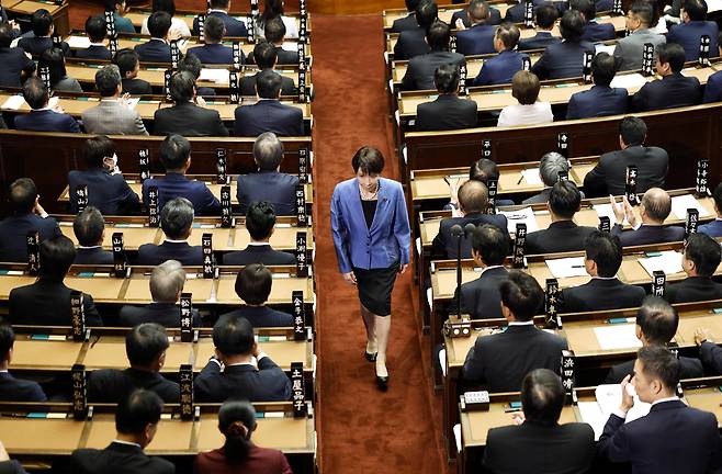 21일 일본 도쿄 중의원에서 다카이치 사나에(가운데) 일본 자민당 총재가 차기 총리를 선출하기 위한 지명 선거에 투표한 후 자리로 돌아가고 있다. /교도 연합뉴스