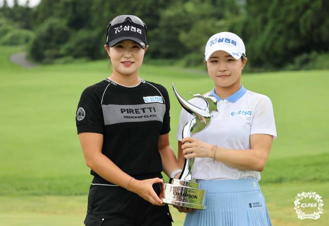 고지원의 우승 트로피를 맞잡은 자매.