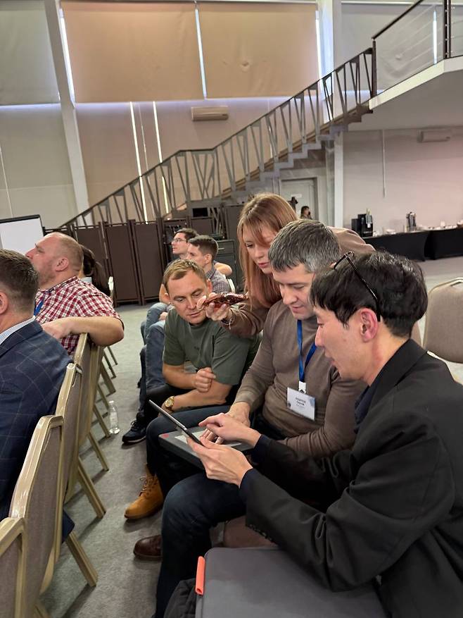 Kobessov Rakhat explains products to the attendees of a conference. [KOBESSOV RAKHAT]