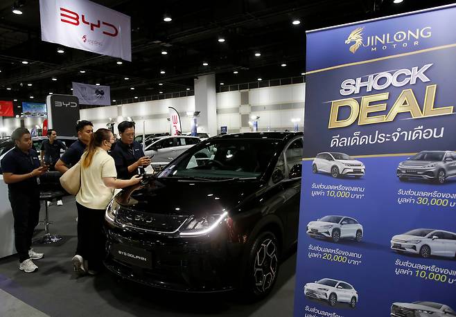 지난달 24일 태국 방콕에서 열린 ‘방콕 전기차 엑스포 2025’에서 영업사원이 현장을 찾은 고객에게 중국 BYD의 전기차 ‘돌핀’ 할인 혜택을 소개하고 있다. 태국은 동남아 최대 자동차 시장으로, 오랫동안 일본차가 시장을 장악했지만 최근 확산하기 시작한 전기차만큼은 중국이 무려 88%를 장악하며, 한국(1%)·미국(6%)·유럽(5%)을 압도하고 있다./EPA연합뉴스