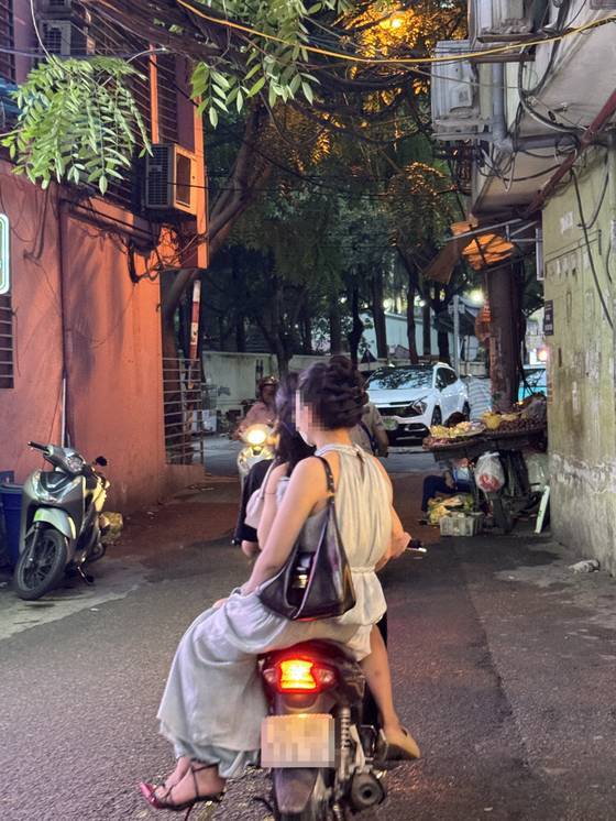 Around 6 p.m. on June 27, a motorcycle carrying several young women arrives at a massage parlor in an alley in Hanoi. [WOMEN MIGRANTS HUMAN RIGHTS CENTER OF KOREA]