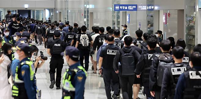 캄보디아 당국의 범죄단지 단속으로 적발돼 구금됐던 한국인들이 2025년 10월18일 오전 인천공항을 통해 송환되고 있다. 이번 송환 대상자들은 ‘웬치’로 불리는 캄보디아 범죄단지에서 보이스피싱이나 로맨스 스캠(사기) 등 범죄에 가담한 혐의를 받고 있다. 이들은 호송차를 타고 충남지방경찰청 등 6개 관할 경찰관서로 압송됐다. 공동취재사진