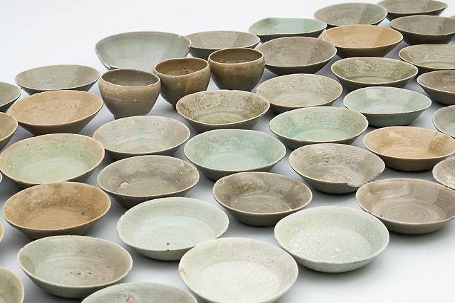 고려시대 난파한 것으로 추정되는 ‘마도5호선’의 선체 파편이 지난달 충남 태안 마도 해역에서 발견됐다(위쪽 사진). 파편 근처에서는 12세기 중후반에 제작된 것으로 보이는 고려청자 87점이 확인됐다. 국립해양유산연구소 제공