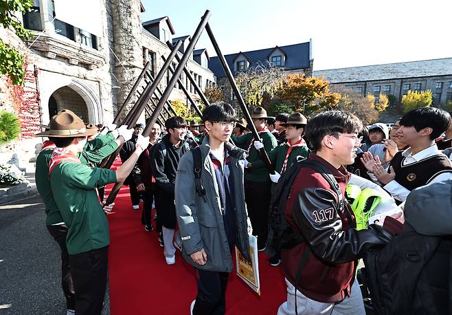 High school seniors leave their school compound in central Seoul with a special ceremony by their teachers and first-year and second-year students on Nov. 12, a day before the College Scholastic Ability Test (CSAT). [YONHAP]