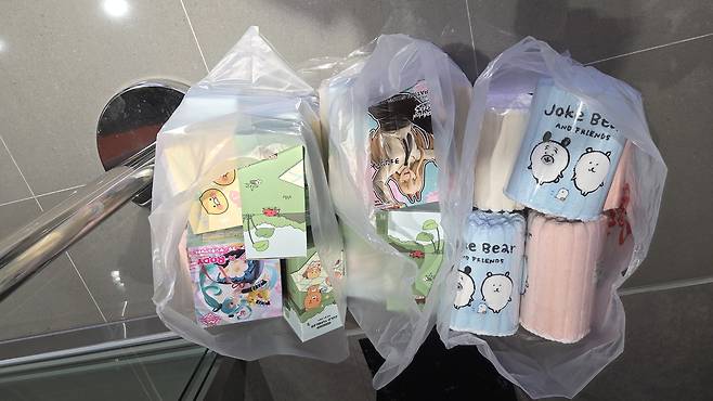 Three Ikea-bag-sized plastic bags filled with prizes Yoo won at Zzang Games arcade in Yongsan on Nov. 3. [WOO JI-WON]