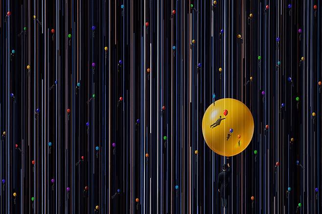 The Happy voyager #02, 2025. 별의 궤적과 각자의 색을 띤 풍선을 들고 나는 중절모 쓴 남자를 통해서 이 넓은 우주에서 우리는 별에서 왔다가 스쳐가는 인연이라는 의미를 표현했다. / 사진가 주기중