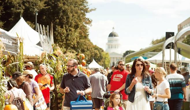 미국 캘리포니아 주의사당이 보이는 새크라멘토 파머스마켓에서 시민들이 농산물들을 둘러보고 있다.  캘리포니아관광청 제공