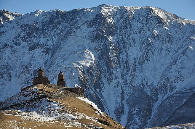 Gergeti Trinity Church stands against the backdrop of Mount Kazbek. [WIKIPEDIA]