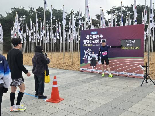 30일 천안 독립기념관에서 열린 2025 천안유관순평화마라톤대회에서 완주를 마친 참가자가 자신의 기록 앞에서 기념촬영을 하고 있다. 박하늘 기자