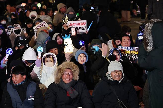 Demonstrators pack the streets in front of the National Assembly on Wednesday to mark the one-year anniversary of Yoon's martial law decree and impeachment, and to call for "just punishments" against Yoon and his aides. (Yonhap)
