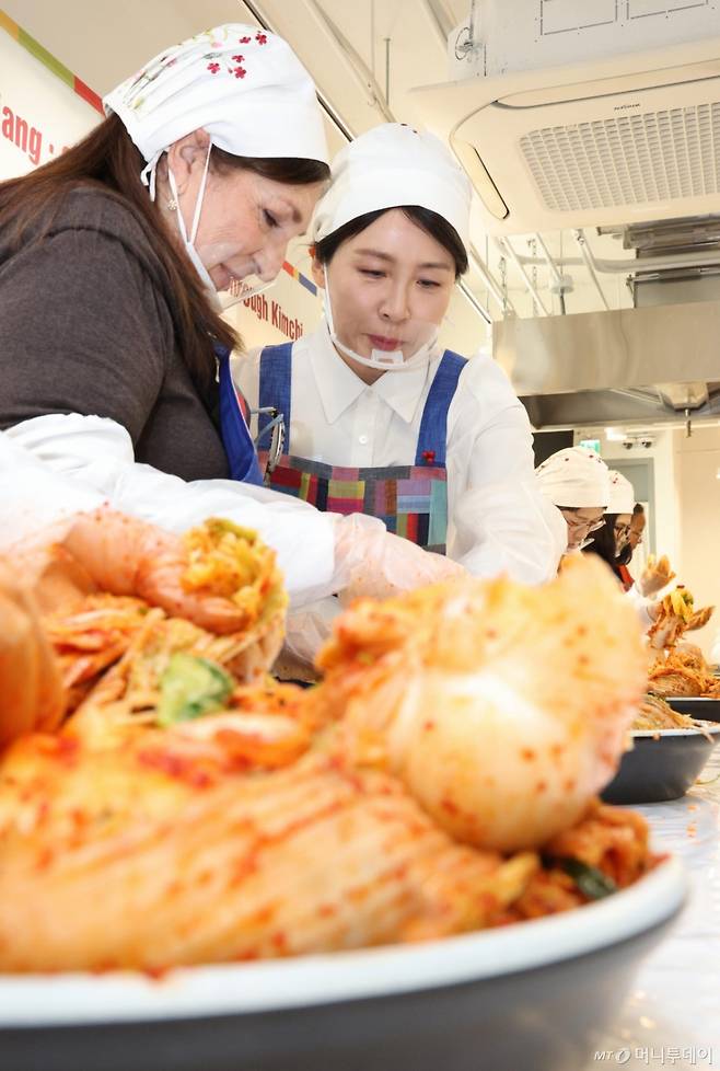 [서울=뉴시스] 고범준 기자 = 김혜경 여사가 9일 서울 종로구 북촌 한식문화공간 이음에서 열린 주한대사 배우자 초청 김장 행사에서 주한 외국대사 배우자들과 함께 김치를 담그고 있다. 2025.12.09. bjko@newsis.com /사진=고범준