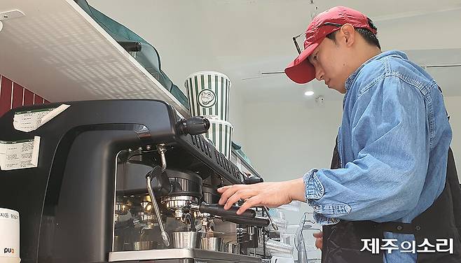 제주시 칠성로상점가 패션의 거리에 위치한 커피 디저트 전문점 백억커피에서 점주 김만복씨가 음료를 만들고 있다. ⓒ제주의소리