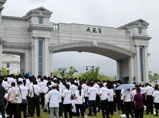 김건희 여사 의혹을 수사하는 민중기 특별검사팀이 통일교 압수수색에 들어간 지난 7월 18일 오후 경기 가평군 천원궁 앞에서 통일교 외국인 신자들이 기도를 하고 있다. 뉴시스