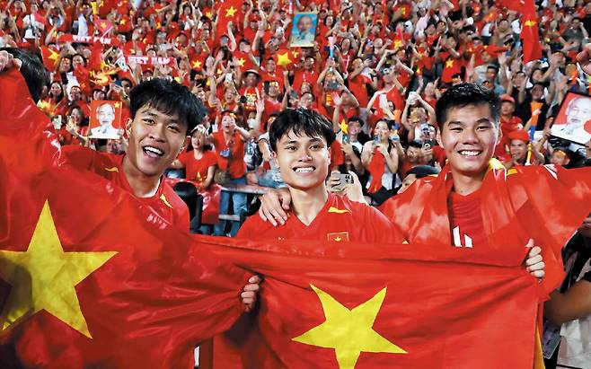 로이터 연합뉴스3관왕의 환희  18일 SEA(동남아시안) 게임 축구 금메달을 딴 베트남 23세 이하 대표팀 선수들이 국기를 흔들며 기뻐하고 있다.