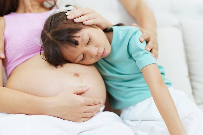 A stock photo of a pregnant woman and a child. (123rf)