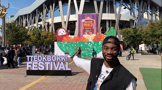 Jason Addy poses for a photo at this year’s Tteokbokki Festival in Daegu during a shoot for his social media content. [SCREEN CAPTURE]