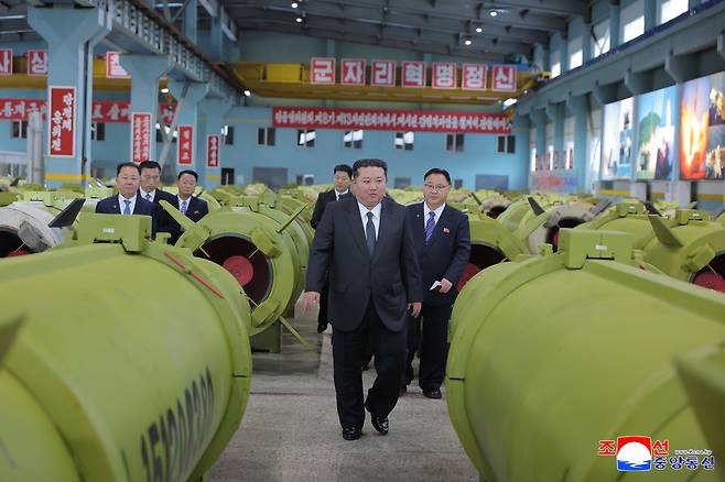 North Korean leader Kim Jong-un (center) inspects the production of missiles and artillery shells during a visit to major munitions industrial enterprises, in this undated photo released by North Korea's official Korean Central News Agency on Friday. (Yonhap)