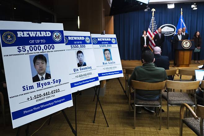 Federal Bureau of Investigation (FBI) wanted list posters with pictures of, from left, North Korean national Sim Hyon-Sop, and Chinese nationals Qin Guoming and Han Linlin, during a news conference at the Justice Department by Assistant Attorney General for National Security Matthew Olsen Tuesday, April 25, 2023, in Washington. [AP/YONHAP]