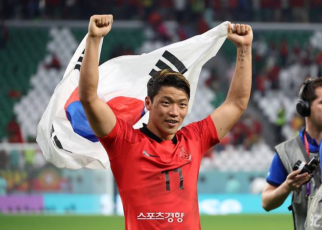 대한민국 축구대표팀 황희찬이 2일(현지시간) 카타르 알라이얀 에듀케이션 시티 스타디움에서 열린 2022 카타르 월드컵 조별리그 H조 포르투갈의 경기 후 16강 진출이 확정되자 태극기를 들고 세레머니를 하고 있다. / 알 라이얀|권도현 기자