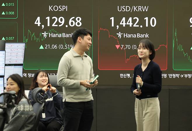 Dealers talk in the dealing room at Hana Bank in Jung District, Seoul, on Dec. 26. The won-dollar exchange rate closed, including after-hours trading, at 1,440.3 won, down 9.5 won on the day. [NEWS1]