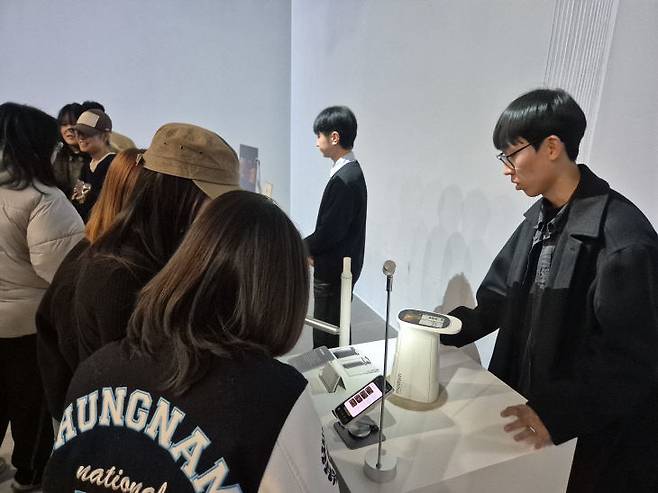 지난 12월 중순에 개최한 충남대 2025년 실용화 캡스톤 디자인 성과 전시회. 캡스톤 디자인 과목을 통해 제품 디자인 성과물을 전시한 학생이 관람객들에게 설명하고 있는 모습이다. (사진=충남대 제공)