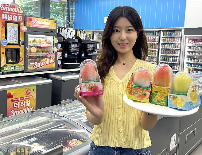 A model holds up frozen sorbet treats at a GS25 convenience store in this photo provided by GS Retail on Aug. 29, 2025. [GS RETAIL]