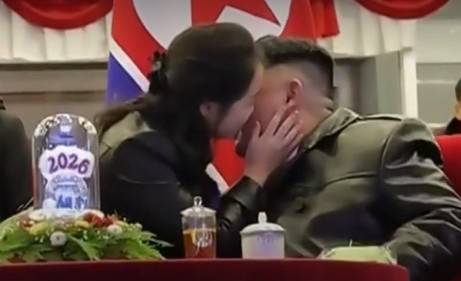 North Korean leader Kim Jong-un is seen being kissed on the cheek by his daugher Kim Ju-ae during a New Year's celebration at the Kumsusan Palace of the Sun on Jan. 1. [YONHAP]