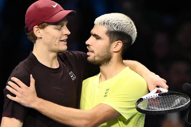 Italy's Jannik Sinner, left, is congratulated by Spain's Carlos Alcaraz at the end of their men's singles final match at the ATP Finals tennis tournament in Turin, on Nov. 16, 2025. [AFP/YONHAP]