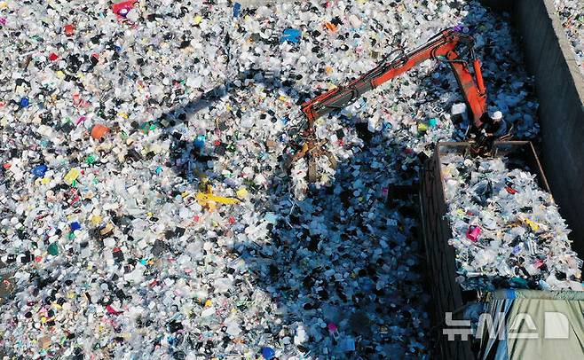 [수원=뉴시스] 김종택 기자 = 식품의약품안전처는 기구 및 용기·포장 제조에 사용하는 물리적 합성수지 재생원료로 폴리에틸렌테레프탈레이트(PET) 뿐 아니라 폴리프로필렌(PP)까지 확대하는 등의 내용을 담은 '기구 및 용기·포장의 기준 및 규격' 일부개정안을 행정예고했다고 8일 밝혔다. 자원 순환의 날을 하루 앞둔 지난해 9월 5일 경기 수원시 영통구 수원시자원순환센터에서 관계자들이 플라스틱 폐기물을 재활용하기 위해 입반출 작업을 하고 있다. 2025.09.05. jtk@newsis.com