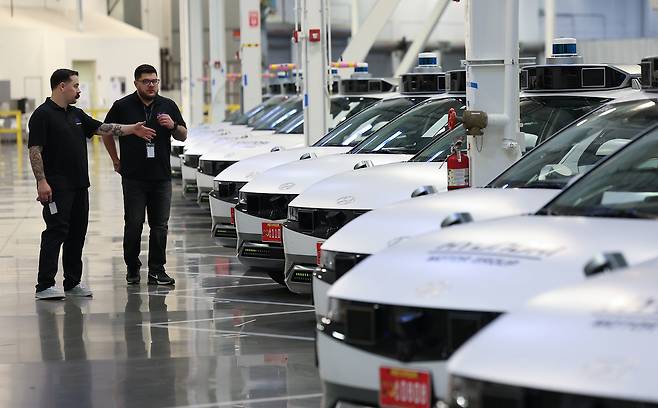 Motional staffers inspect the Ioniq 5 robotaxi fleet, lined up at the company’s technical center in Las Vegas, Nevada on Thursday. (Yonhap)