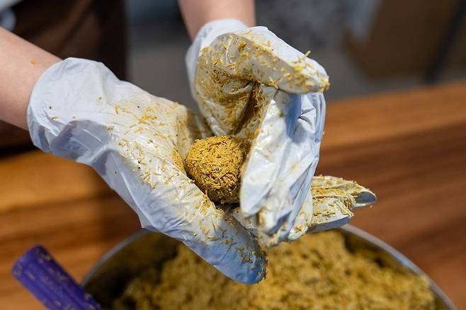 피스타치오 스프레드와 녹인 화이트초콜릿, 구운 카다이프를 섞어 완성한 쿠키 속을 둥글게 빚고 있다. 홍태식