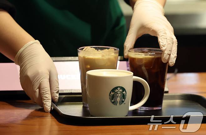 사진은 이날 서울 시내 한 스타벅스 매장에서 직원이 커피를 비롯한 음료를 만들어 고객에게 전달하고 있다. 2025.1.24/뉴스1 ⓒ News1 김진환 기자