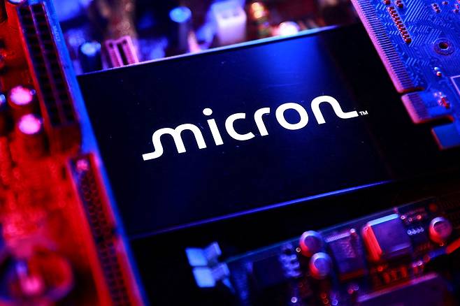 A Micron logo and a computer motherboard appear in this illustration created on Aug. 25, 2025. [REUTERS/YONHAP]