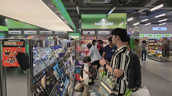 Customers are seen browsing products at an Olive Young store in Jung District, central Seoul on Sept. 29. [NOH YU-RIM]