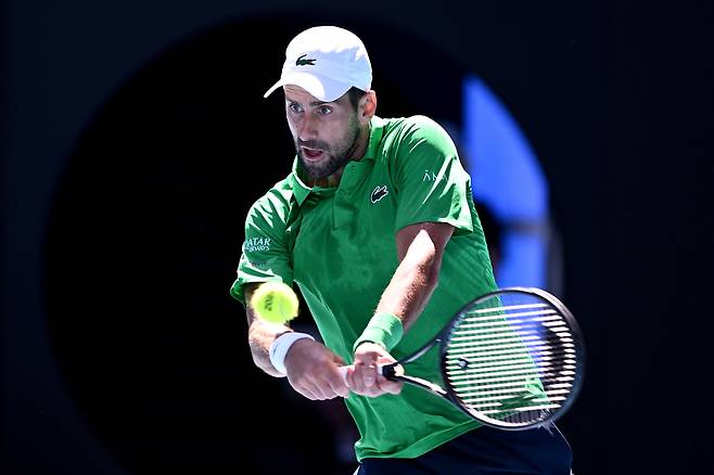 노바크 조코비치가 22일 호주 멜버른에서 열린 프란체스코 마에스트렐리와의 호주오픈 남자 단식 2회전에서 백핸드를 치고 있다.     멜버른 | EPA연합뉴스